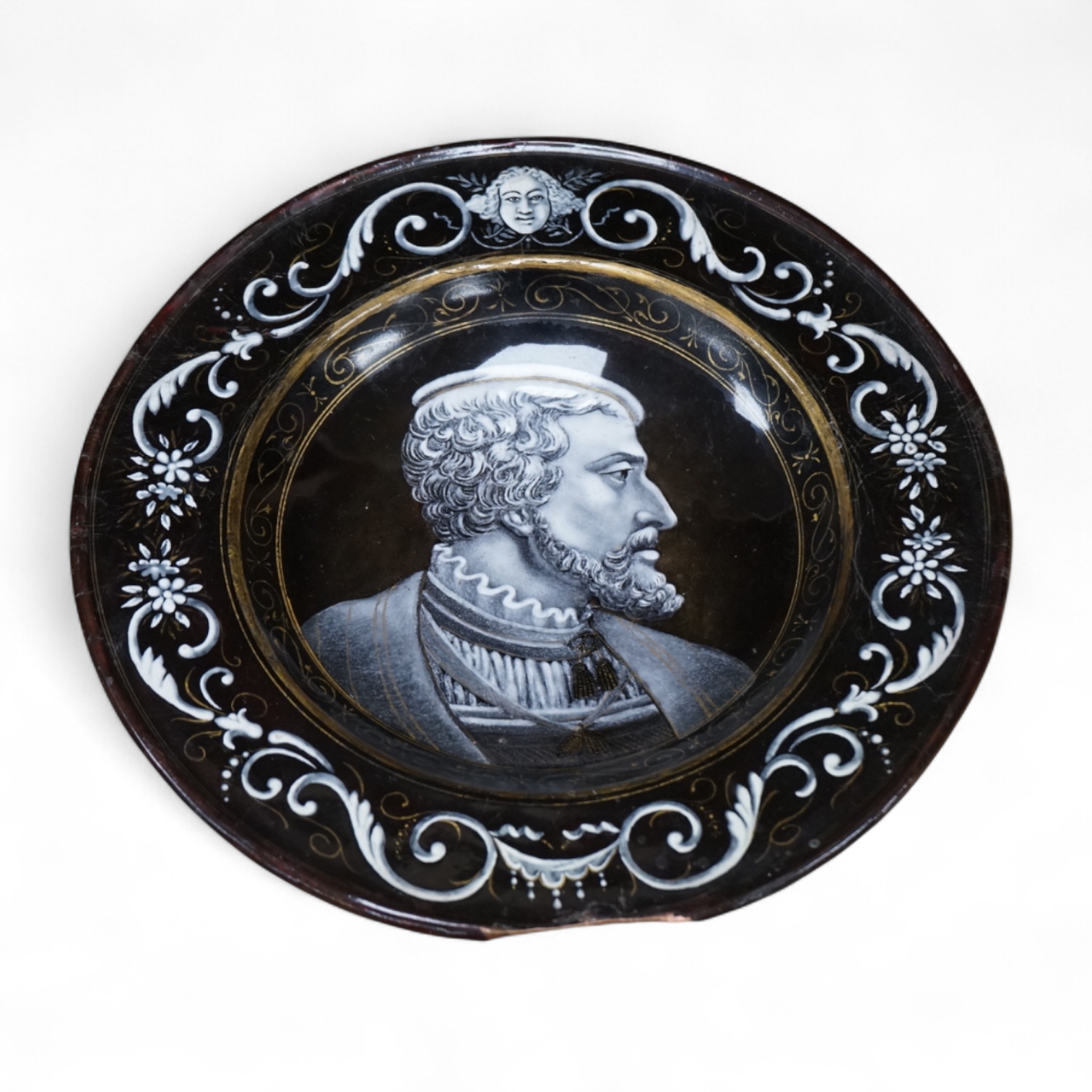 A Limoges style enamel on copper dish, decorated with a portrait of a gentleman in profile, 22cm in diameter